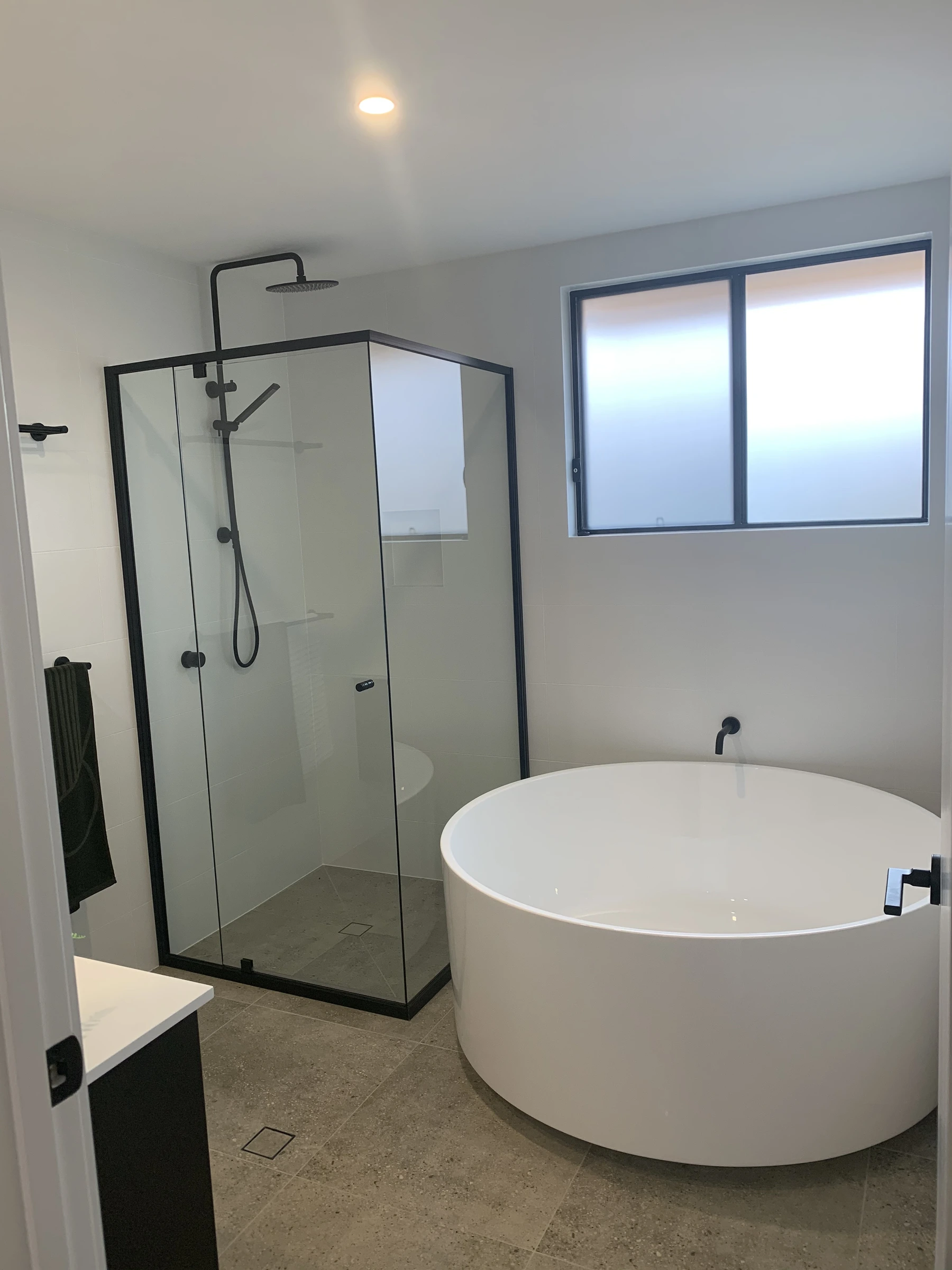 Round freestanding bath and glass shower renovation Gold Coast